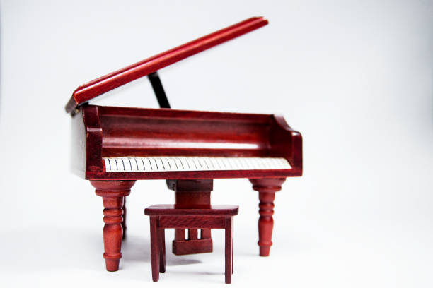 istock miniature classic piano keyboard instrument isolated on white background 1154130016