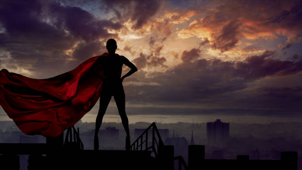 Portrait of young hero woman with super person red cape guard city stock photo