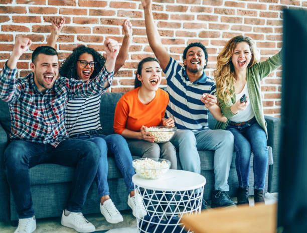 istock Group of friends watching sport together 1154131208