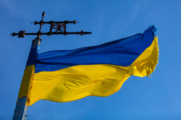 istock Ukrainian flag on sky background 1154131270