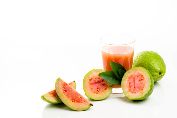 istock Guava juice and peeled fruit on white background 1154131903