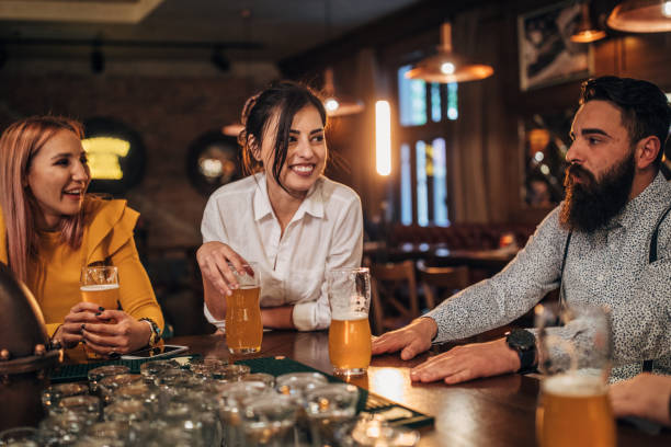istock Friends talking and drinking beer in a pub 1154133239