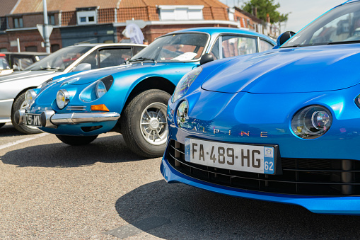 Wattrelos,FRANCE-June 02,2019: blue new and old Renault Alpine A110,front view,car exhibited at the Renault Wattrelos Martinoire parking lot.