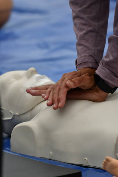 CPR Demonstration with Dummy Face and Light Hand Press Manhattan Beach Area Public Safety Course steven harrie stock pictures, royalty-free photos & images