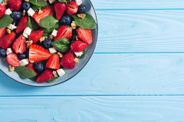 istock Summer Strawberry salad with spinach , cheese , nuts and blueberry 1154142839
