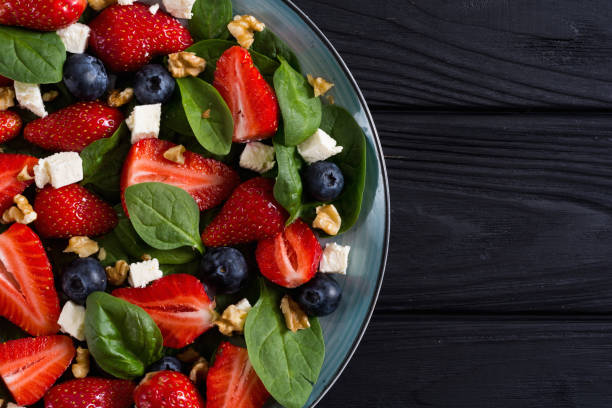 istock Summer Strawberry salad with spinach , cheese , nuts and blueberry 1154142845