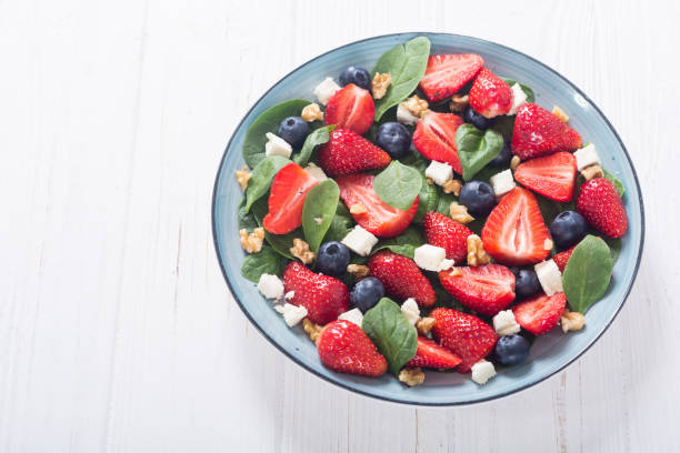 istock Summer Strawberry salad with spinach , cheese , nuts and blueberry 1154142847