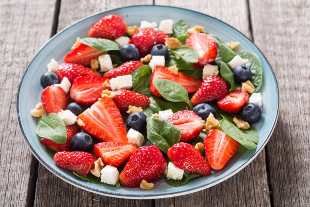 istock Summer Strawberry salad with spinach , cheese , nuts and blueberry 1154142883