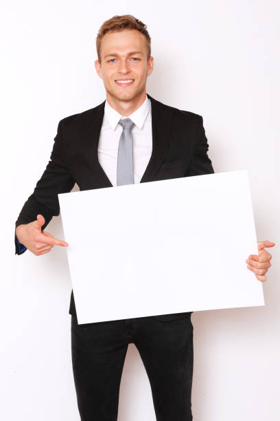 istock Elegant man showing a white banner. 1154143293