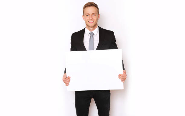 istock Elegant man in suit holding a banner. 1154143299