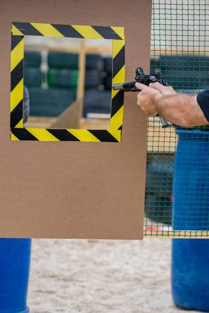 istock man shooting with the gun at shooting range 1154145076