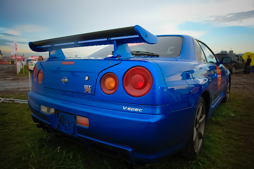 Moscow, Russia - May 25, 2019: The blue color Nissan skyline GTR R34 stands on the grass