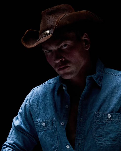 istock Cowboy posing in a sexy manner 1154159320