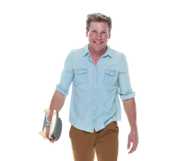 istock Casual well dressed man walking with a skateboard 1154162300