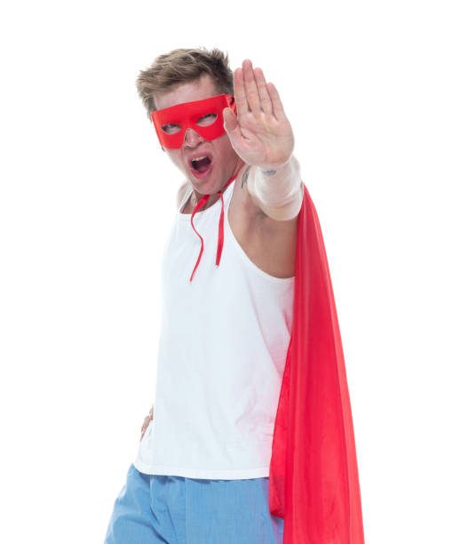 istock Man wearing pajamas and super hero cape 1154162430