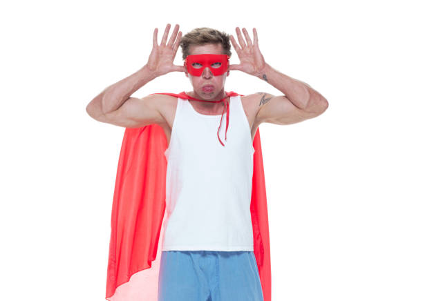 istock Man wearing pajamas and super hero cape 1154162629