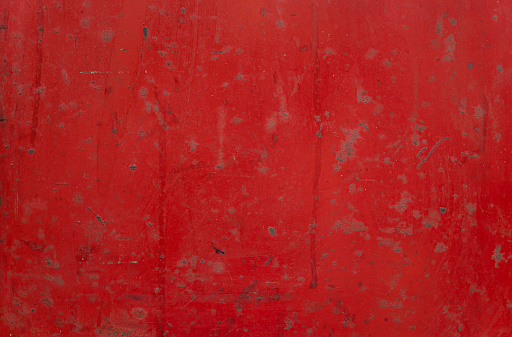 Distressed, dust, and weathered red metal background and texture with copy space