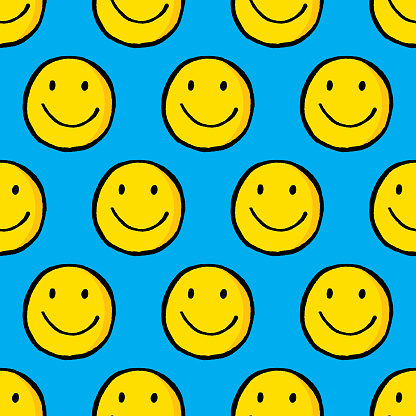 Vector illustration of hand drawn smiley faces in a repeating pattern against a blue background.