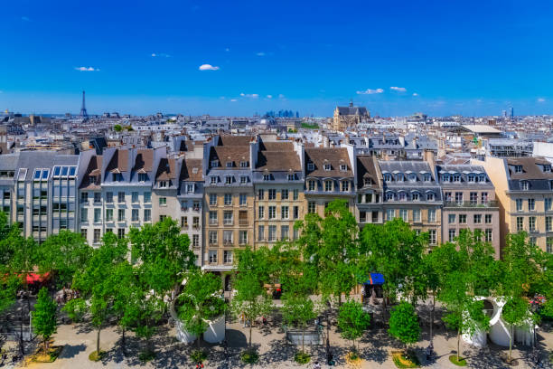 Paris, typical roofs in the Marais Paris, typical roofs in the Marais, aerial view with the Eiffel Tower and the Defense in background pompidou center stock pictures, royalty-free photos & images