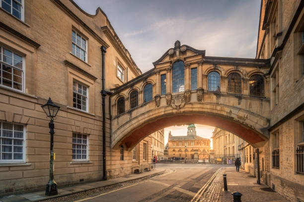 Bridge of sign Bridge of sign with the Sheldonian theatre background and street lamp foreground during sunset at Oxford, UK oxford england stock pictures, royalty-free photos & images