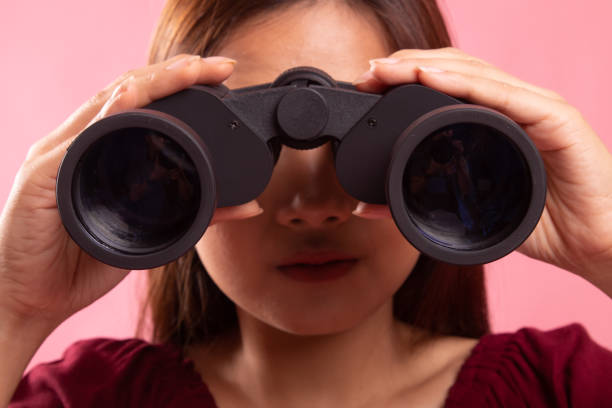istock Young Asian woman with binoculars. 1154181958