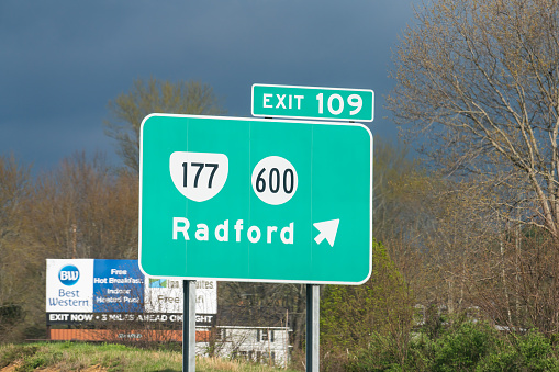 Radford, USA - April 19, 2018: University exit sign on highway in Virginia with Best Western hotel billboard