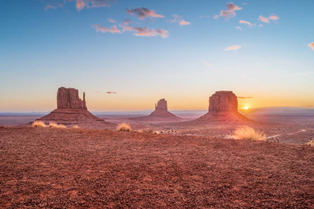 Stock photograph of the Mittens and Merrick butte in Monument Valley, Arizona, USA during sunrise.