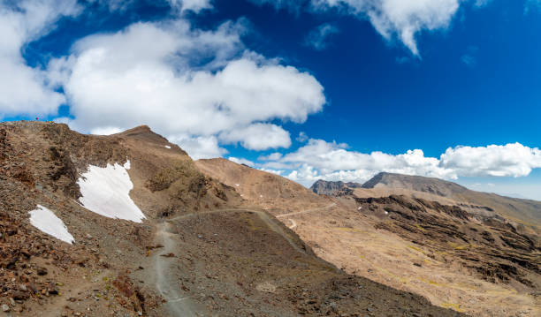 istock Clouds over mountain ridge in Sierra Nevada, Granada 1154205716