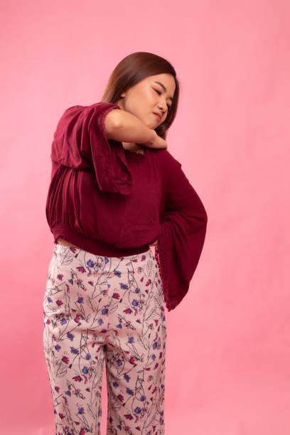 istock Young Asian woman got back pain. 1154207141