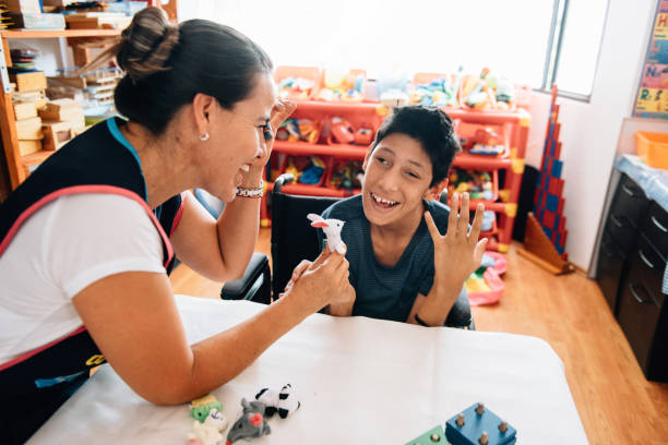 istock Teacher playing with boy with Cerebral Palsy 1154211997