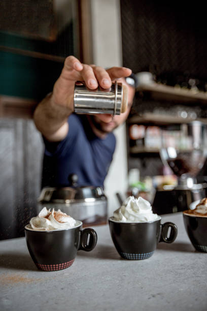 istock Sprinkling cinnamon on mocha coffee 1154220660
