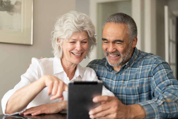 istock Senior couple using electronic tablet to video chat 1154221291