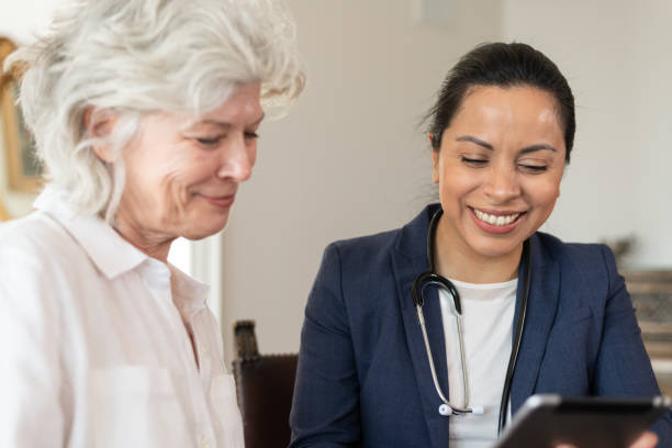 istock Female doctor using tablet with senior patient 1154221308
