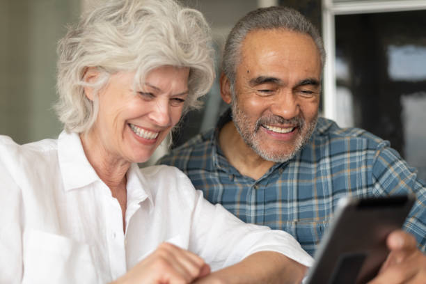 istock Senior couple using electronic tablet to video chat 1154221312