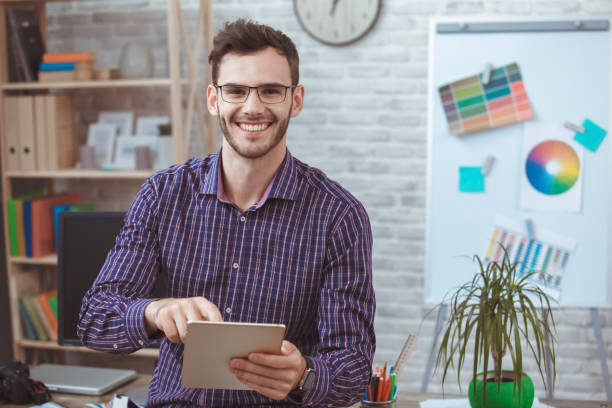 istock Graphic designer small business home office concept holding digital tablet 1154222729