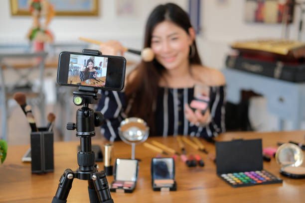 istock beauty blogger live broadcasting cosmetic makeup tutorial on social media. 1154223563