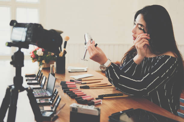 istock beauty blogger live broadcasting cosmetic makeup tutorial on social media. 1154223580