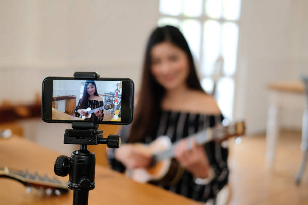istock blogger live broadcasting music instrument tutorial on social media. vlogger recording online vlog video. 1154223655