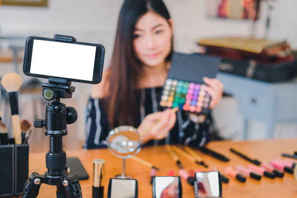 istock beauty blogger live broadcasting cosmetic makeup tutorial on social media. 1154223670