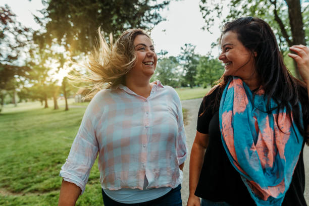 istock Happy friends walking in the park 1154226614