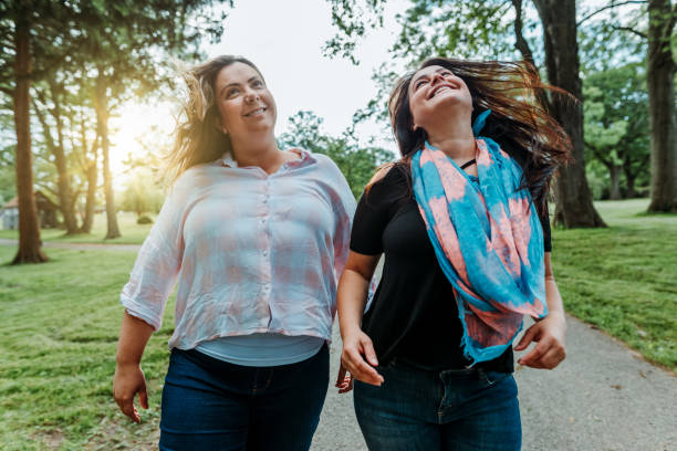 istock Happy friends walking in the park 1154226633
