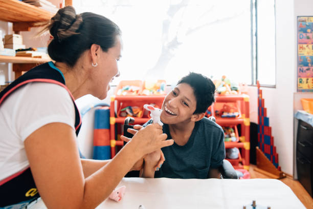istock Teacher playing with boy with Cerebral Palsy 1154226963