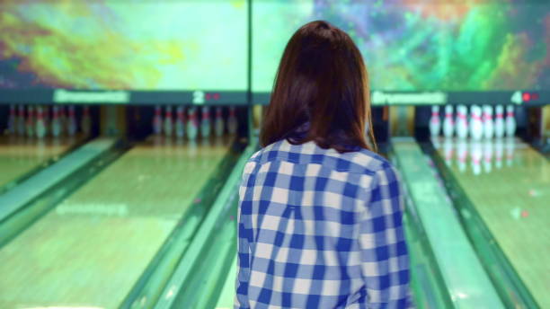 istock Girl knocks down pins at the bowling 1154228658