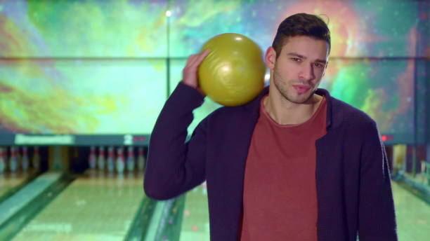 istock Guy holds the bowling ball on his shoulder 1154228784