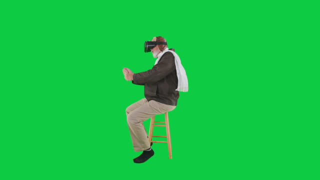 Adult senior male caucasian playing virtual reality WWi Ace wearing VR goggles