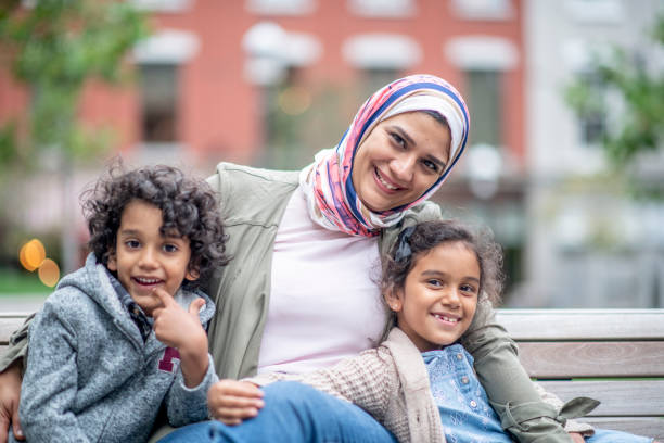 istock Muslim family sitting on a bench 1154229974