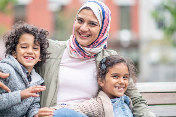 istock Muslim family sitting on a bench 1154230011