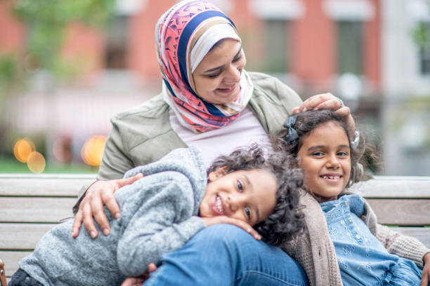 Muslim family sitting on a bench