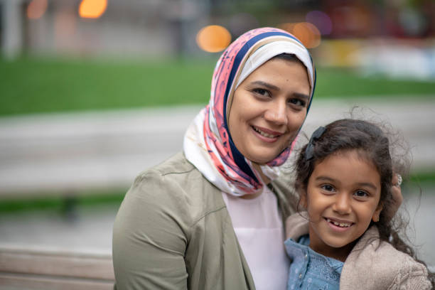 istock Muslim family sitting on a bench 1154230075