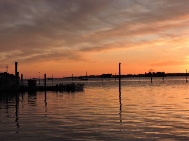 istock Orange colorful sky at sunset over water 1154234499